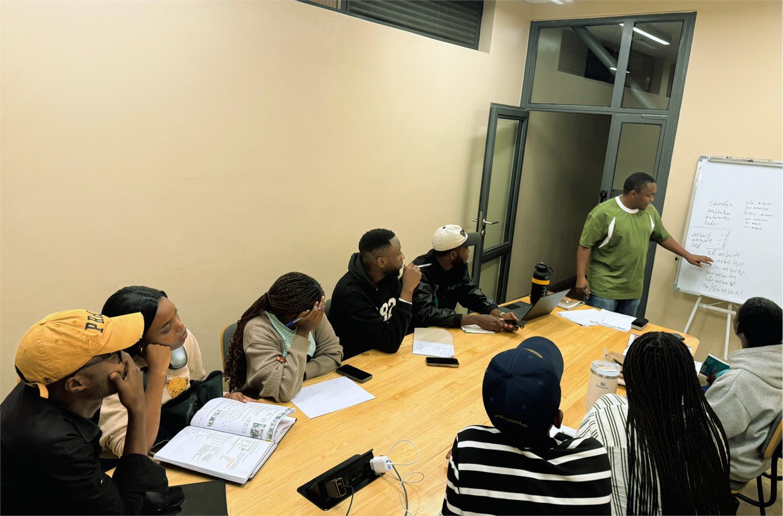 Students in a German class at Kigali German Language Institute, following a lesson at the whiteboard